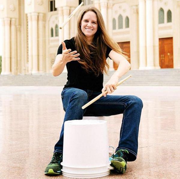 Photo of a woman playing drums.